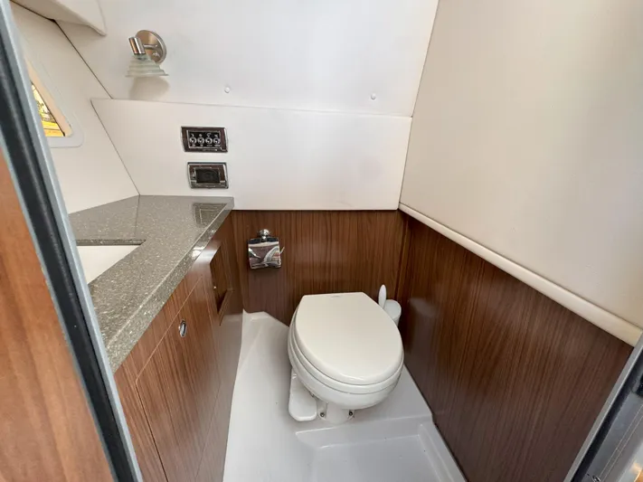 Love You More Yacht Photos Pics 2019 Four Winns H350 boat bathroom with wood paneling and modern fixtures.