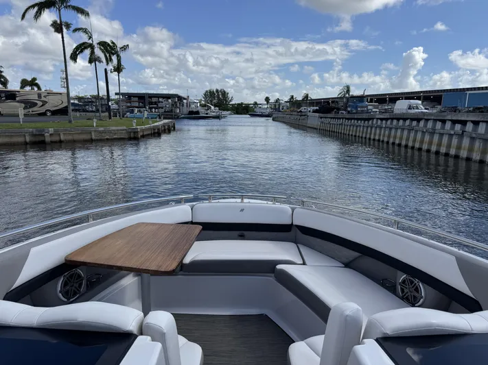 Love You More Yacht Photos Pics 2019 Four Winns H350 boat interior with seating and table, docked in a marina.