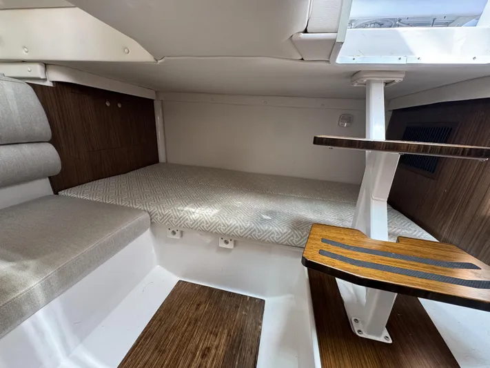 Love You More Yacht Photos Pics 2019 Four Winns H350 cabin interior with wooden steps and cushioned seating area.