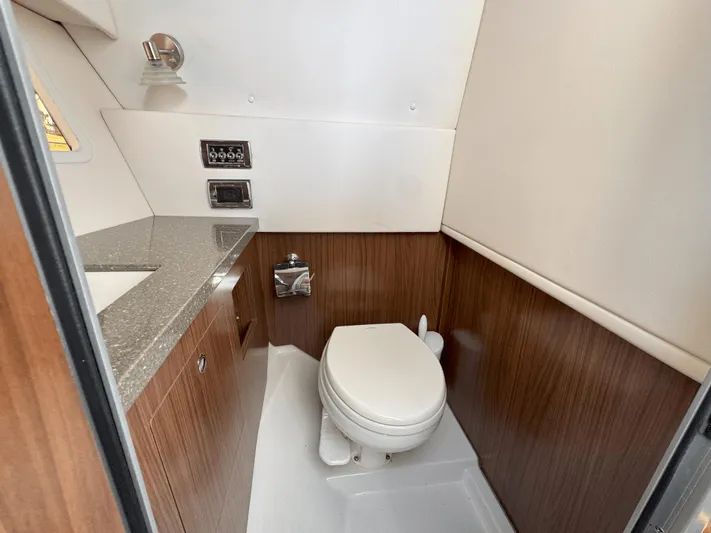 Love You More Yacht Photos Pics 2019 Four Winns H350 boat bathroom with modern fixtures and wood paneling.