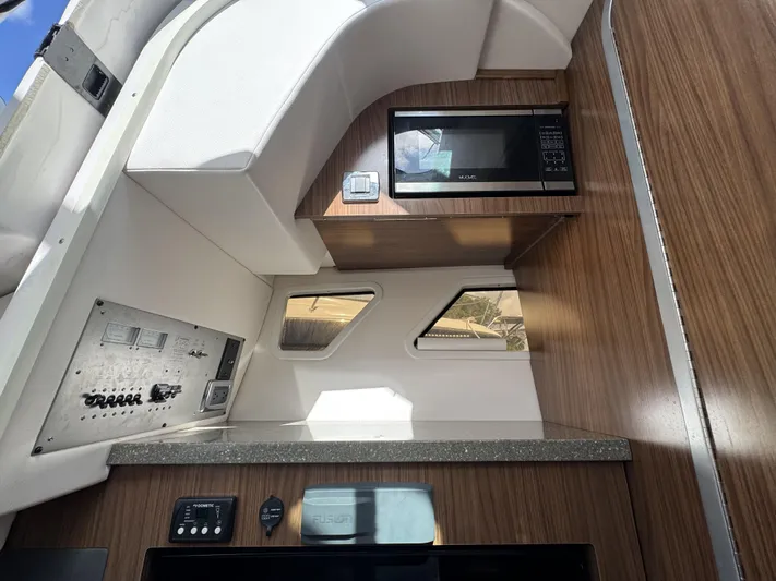 Love You More Yacht Photos Pics Interior of 2019 Four Winns 350H boat with microwave and control panel.