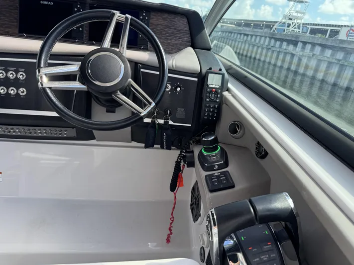 Love You More Yacht Photos Pics 2019 Four Winns 350H helm with steering wheel, controls, and navigation equipment.