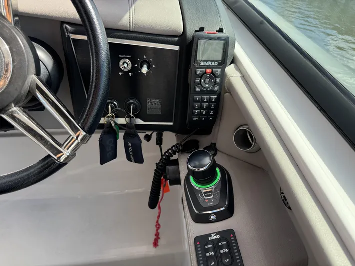 Love You More Yacht Photos Pics Control panel of 2019 Four Winns 350H boat with steering wheel and navigation equipment.