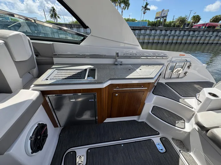 Love You More Yacht Photos Pics 2019 Four Winns 350H boat interior with kitchenette, featuring grill and storage cabinets.