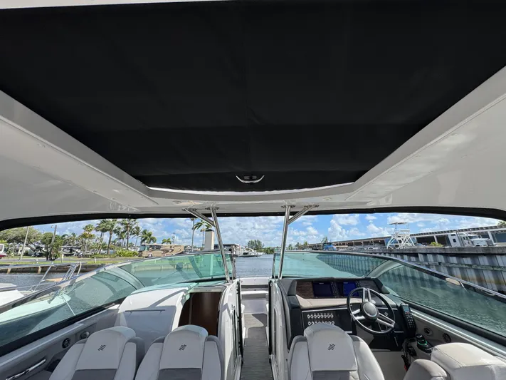 Love You More Yacht Photos Pics 2019 Four Winns 350H boat interior with helm, seating, and open canopy.