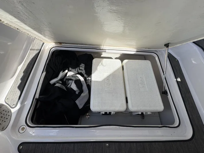 Love You More Yacht Photos Pics Storage compartment on a 2019 Four Winns 350H boat with coolers and clothing.