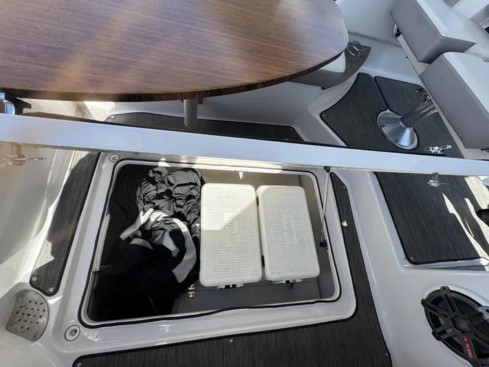 Love You More Yacht Photos Pics 2019 Four Winns 350H boat interior with storage compartment and Igloo cooler.