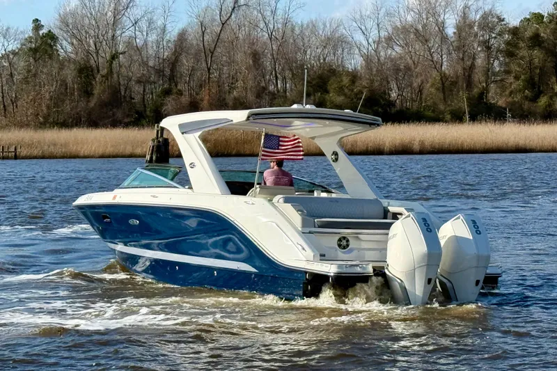  Yacht Photos Pics 2021 Sea Ray SLX 310 Outboard cruising on a scenic river.