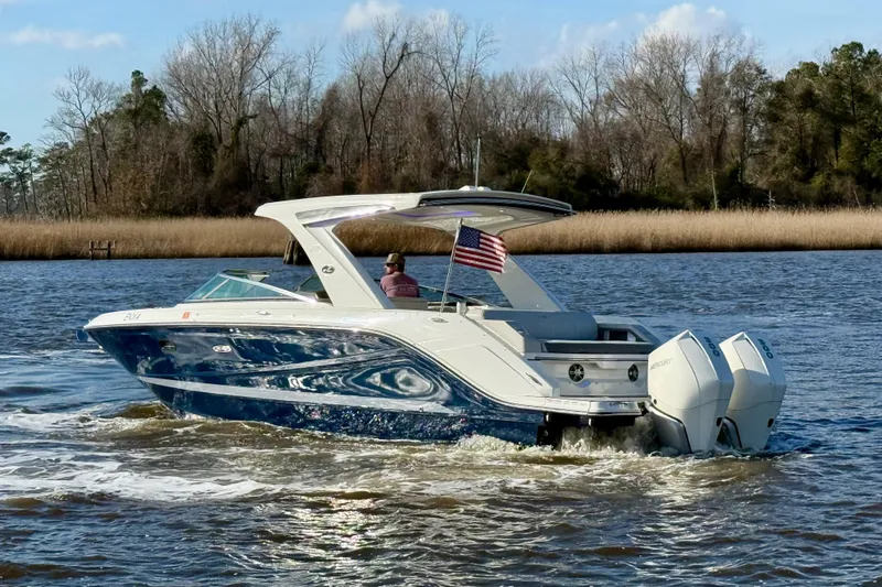  Yacht Photos Pics 2021 Sea Ray SLX 310 Outboard cruising on a scenic river with American flag.