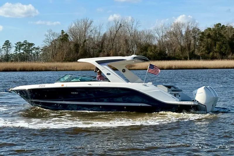  Yacht Photos Pics 2021 Sea Ray SLX 310 Outboard cruising on a river with American flag.