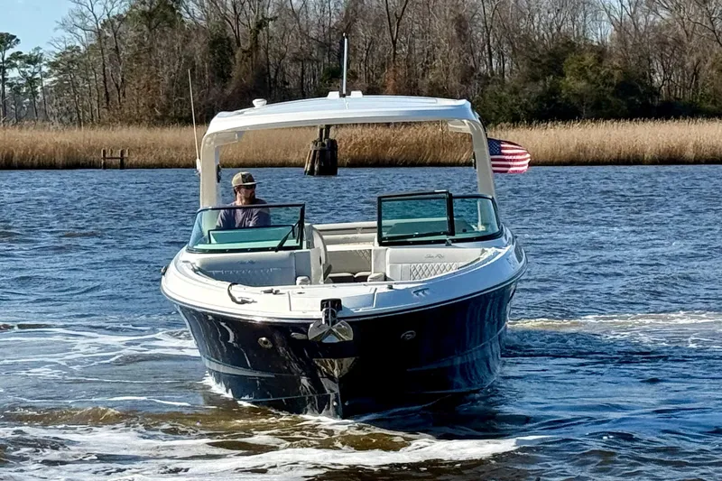  Yacht Photos Pics 2021 Sea Ray SLX 310 Outboard cruising on a serene river with trees in the background.