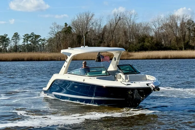  Yacht Photos Pics 2021 Sea Ray SLX 310 Outboard cruising on a scenic river.