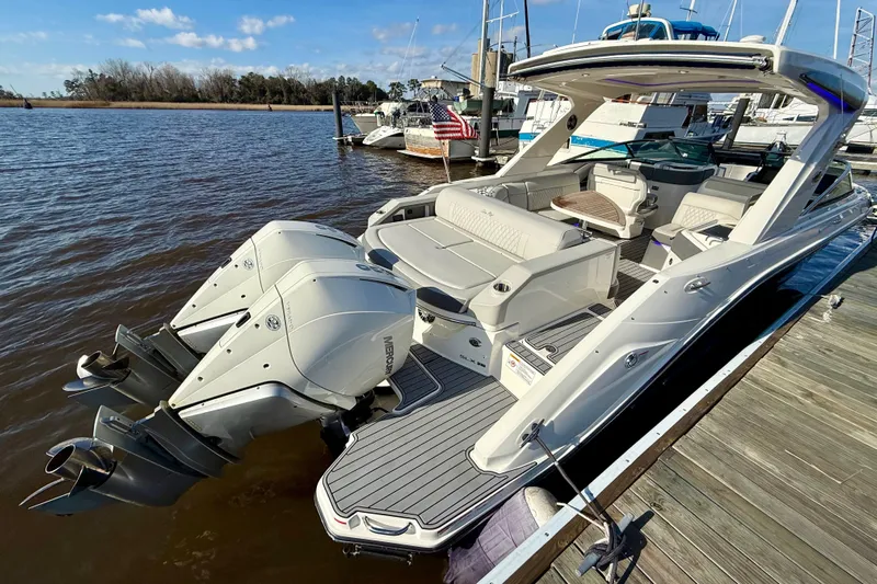  Yacht Photos Pics 2021 Sea Ray SLX 310 Outboard boat docked, featuring dual engines and spacious seating.