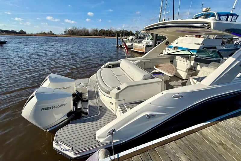  Yacht Photos Pics 2021 Sea Ray SLX 310 Outboard boat docked, featuring spacious seating and dual Mercury engines.