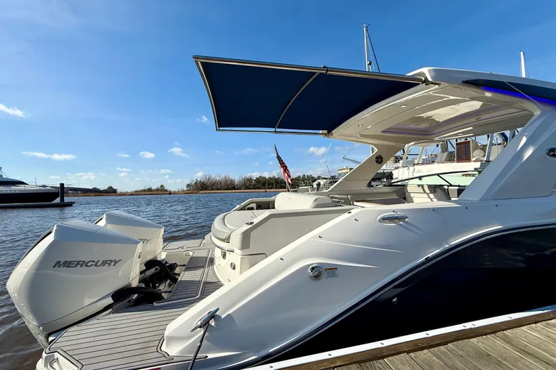  Yacht Photos Pics 2021 Sea Ray SLX 310 Outboard boat with Mercury engines docked by the water.