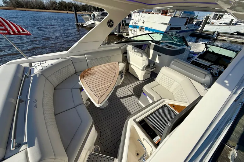  Yacht Photos Pics Luxurious 2021 Sea Ray SLX 310 Outboard boat interior with elegant seating and wooden table.