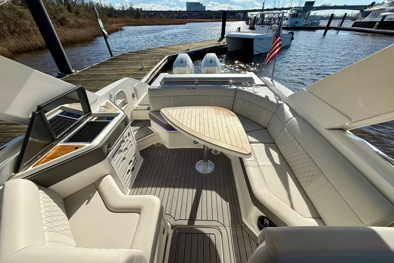  Yacht Photos Pics Luxurious 2021 Sea Ray SLX 310 Outboard boat interior with seating and table.
