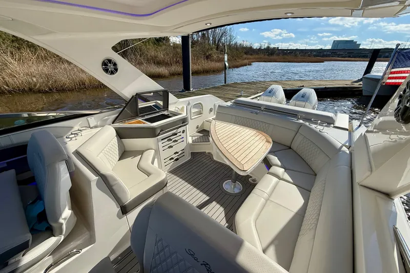  Yacht Photos Pics Luxurious 2021 Sea Ray SLX 310 Outboard boat interior with elegant seating and table.