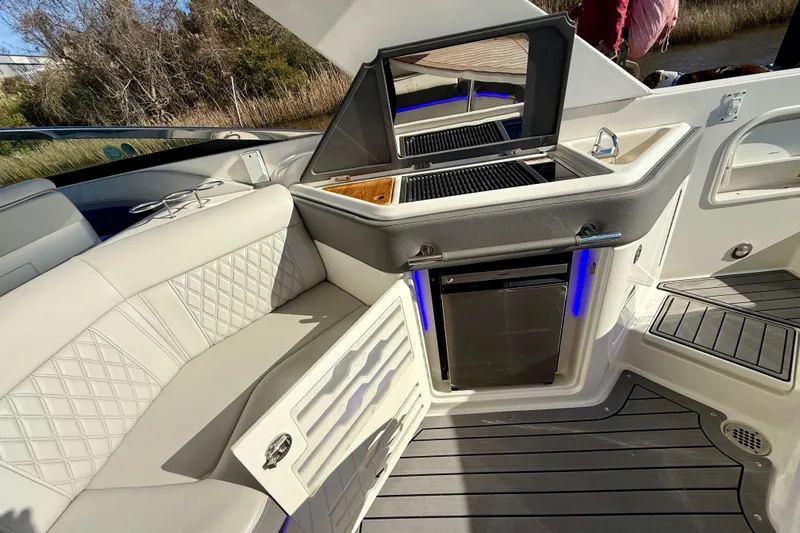  Yacht Photos Pics Luxurious interior of 2021 Sea Ray SLX 310 Outboard with seating and kitchenette.