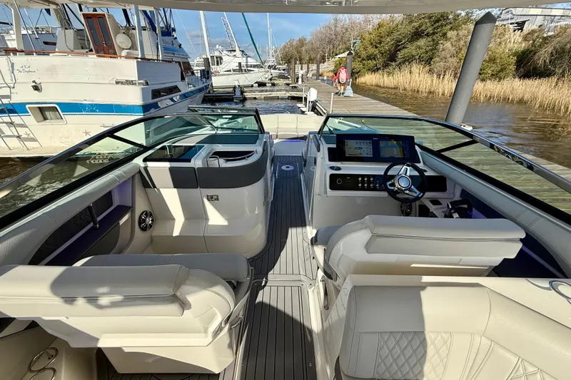  Yacht Photos Pics Interior view of 2021 Sea Ray SLX 310 Outboard, featuring luxurious seating and modern dashboard.