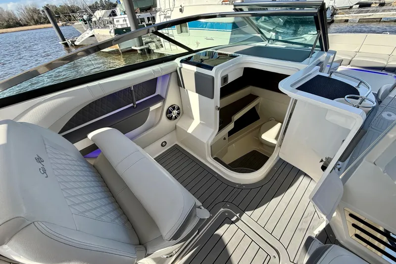  Yacht Photos Pics 2021 Sea Ray SLX 310 Outboard interior with seating and cabin view at a marina.