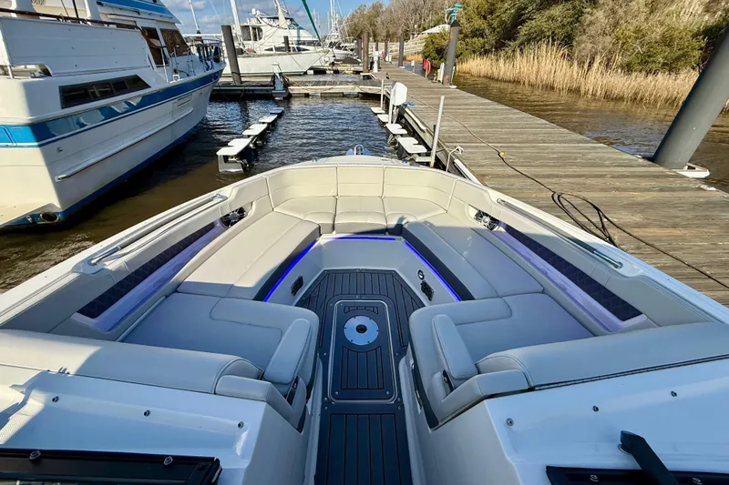  Yacht Photos Pics 2021 Sea Ray SLX 310 Outboard boat interior with luxurious seating at a marina.
