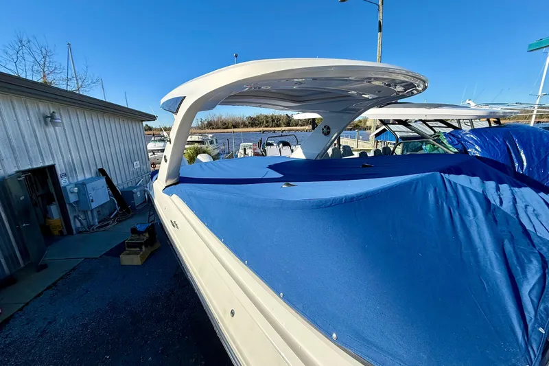 Yacht Photos Pics 2021 Sea Ray SLX 310 Outboard boat covered with blue tarp at marina.