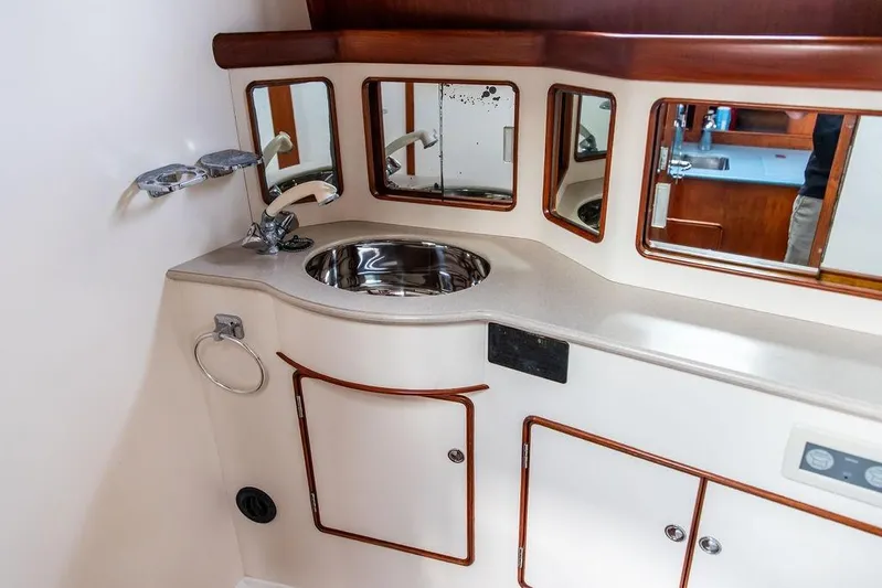 Renegade Yacht Photos Pics 1994 Little Harbor Express yacht bathroom with sink, mirrors, and storage cabinets.
