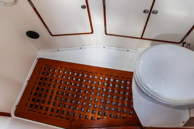 Renegade Yacht Photos Pics 1994 Little Harbor Express boat bathroom with wooden floor grate and white toilet.