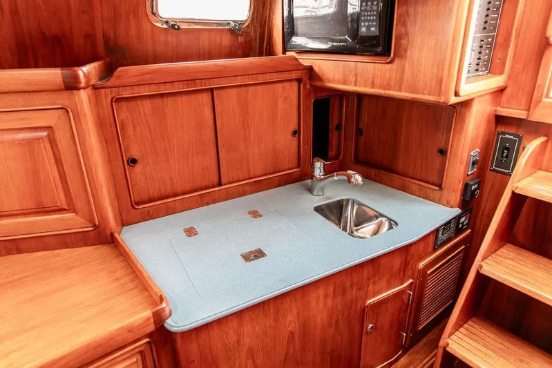 Renegade Yacht Photos Pics 1994 Little Harbor Express yacht interior with wooden cabinetry and compact sink area.