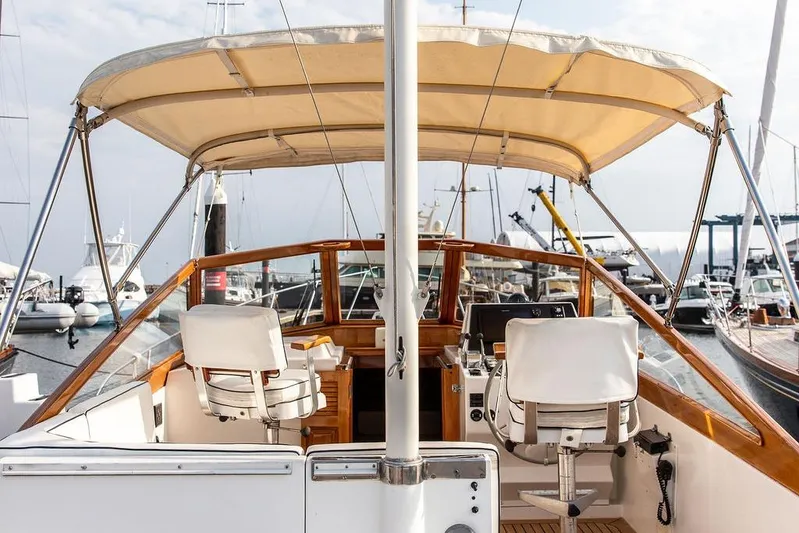 Renegade Yacht Photos Pics 1994 Little Harbor Express yacht interior with helm, chairs, and canopy in marina setting.