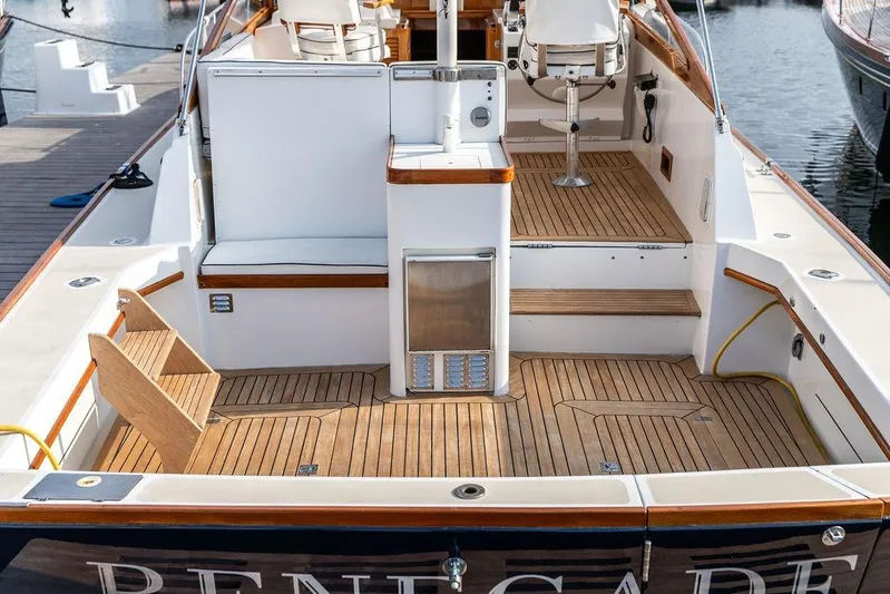 Renegade Yacht Photos Pics 1994 Little Harbor Express boat with teak deck and seating area at a marina.