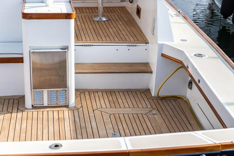 Renegade Yacht Photos Pics 1994 Little Harbor Express boat deck with teak flooring and built-in storage.