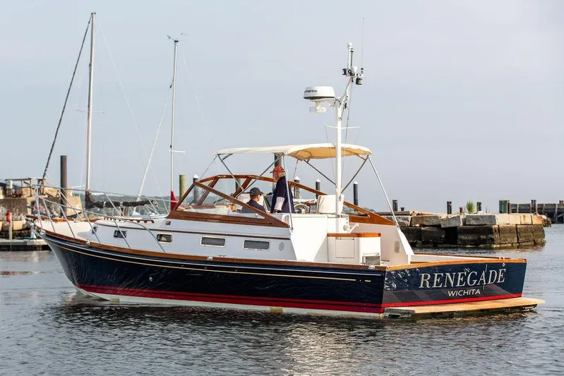 Renegade Yacht Photos Pics 1994 Little Harbor Express boat "Renegade" on water near dock, clear sky background.