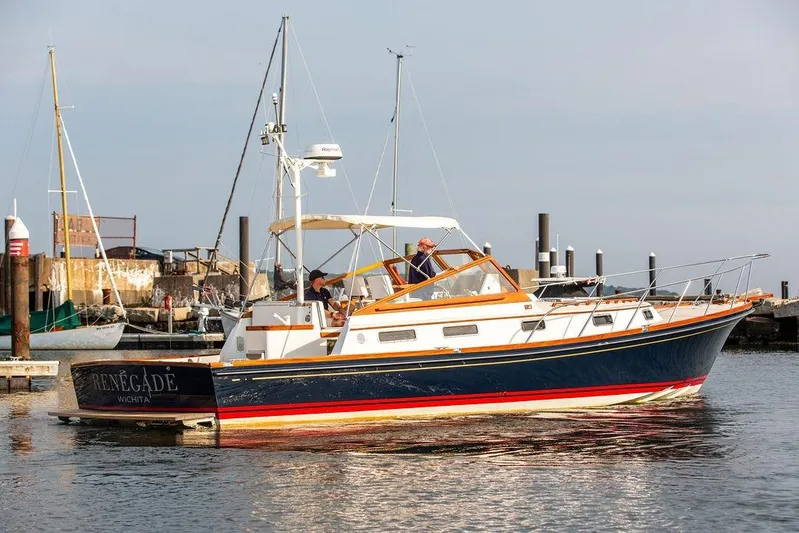 Renegade Yacht Photos Pics 1994 Little Harbor Express yacht docked at a marina, featuring a sleek design and vibrant colors.