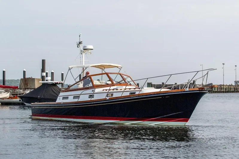 Renegade Yacht Photos Pics 1994 Little Harbor Express yacht cruising in a marina, featuring classic design and sleek lines.