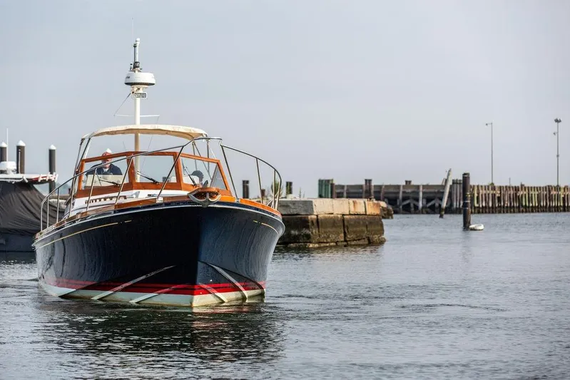 Renegade Yacht Photos Pics 1994 Little Harbor Express boat navigating a calm harbor near a dock.