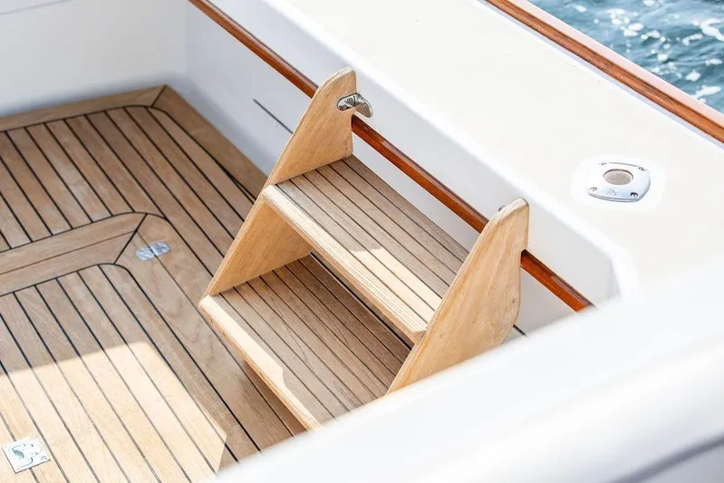 Renegade Yacht Photos Pics Wooden steps on 1994 Little Harbor Express boat deck, featuring elegant teak finish.