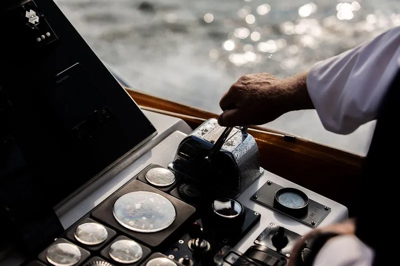 Renegade Yacht Photos Pics Close-up of a hand operating the controls of a 1994 Little Harbor Express boat.
