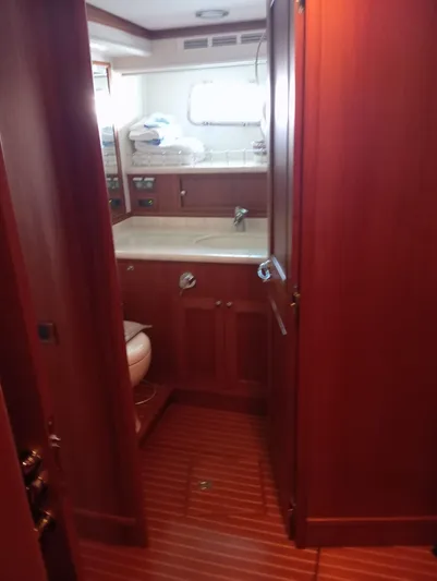 Saturnia Yacht Photos Pics Interior of 2009 Grand Banks 59 Aleutian RP yacht, featuring wooden cabinetry and compact bathroom.