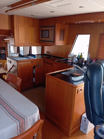 Saturnia Yacht Photos Pics 2009 Grand Banks 59 Aleutian RP yacht interior with wooden cabinetry and modern kitchen amenities.