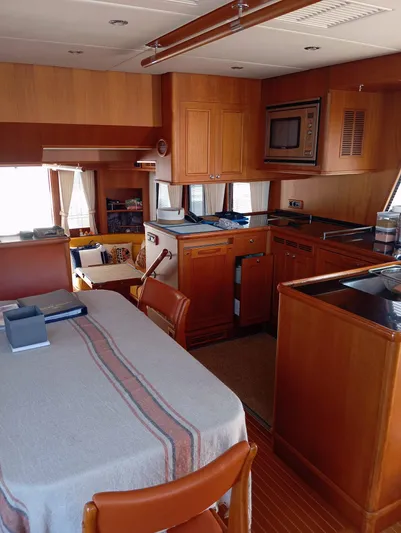 Saturnia Yacht Photos Pics Interior of 2009 Grand Banks 59 Aleutian RP yacht with kitchen and dining area.