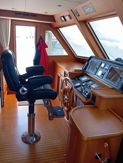 Saturnia Yacht Photos Pics Helm of 2009 Grand Banks 59 Aleutian RP yacht with navigation equipment and captain's chair.