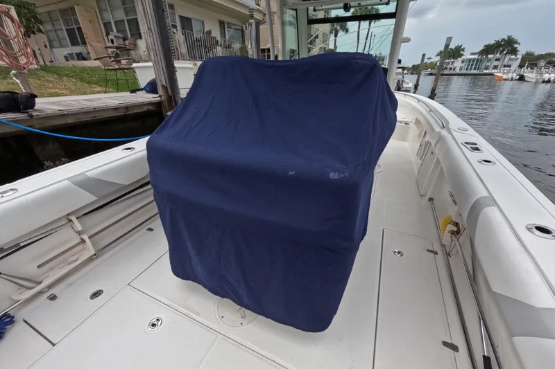 32 Boston Whaler Outrage 2013 Yacht Photos Pics 2013 Boston Whaler 320 Outrage boat interior with covered console, docked by waterfront homes.