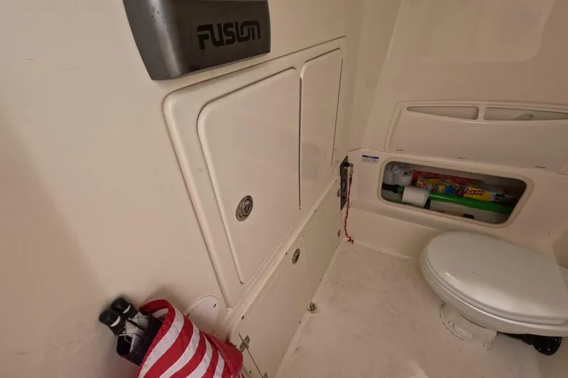 32 Boston Whaler Outrage 2013 Yacht Photos Pics Interior of 2013 Boston Whaler 320 Outrage boat with storage and toilet.