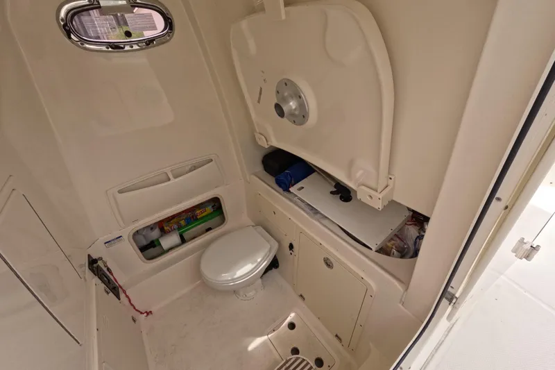 32 Boston Whaler Outrage 2013 Yacht Photos Pics Interior of 2013 Boston Whaler 320 Outrage boat featuring a compact marine toilet.