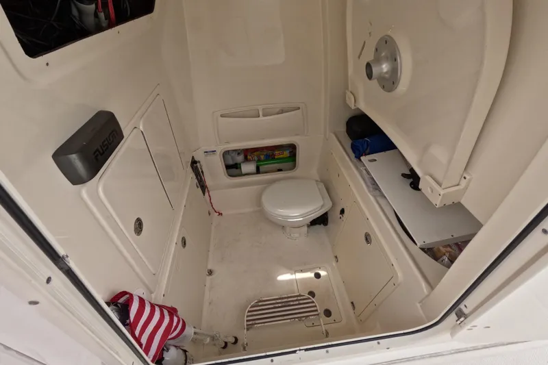 32 Boston Whaler Outrage 2013 Yacht Photos Pics Interior of 2013 Boston Whaler 320 Outrage boat, featuring a compact marine toilet.