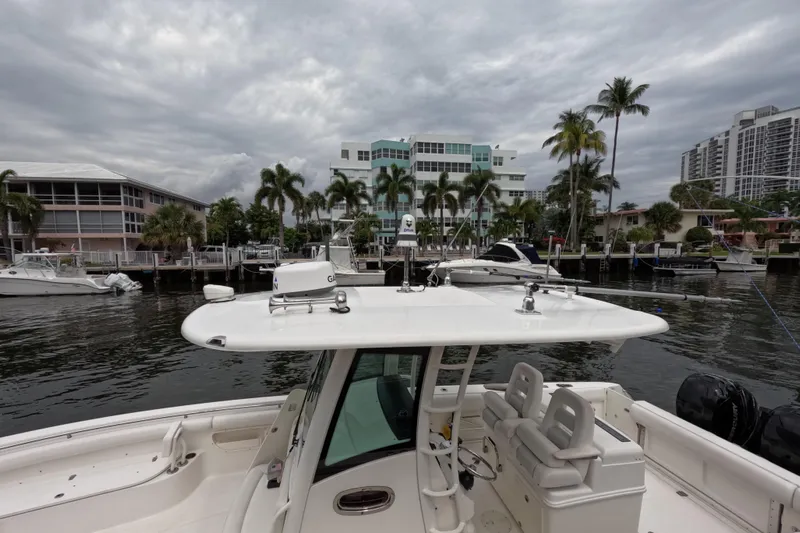 32 Boston Whaler Outrage 2013 Yacht Photos Pics 2013 Boston Whaler 320 Outrage docked near waterfront buildings and palm trees.