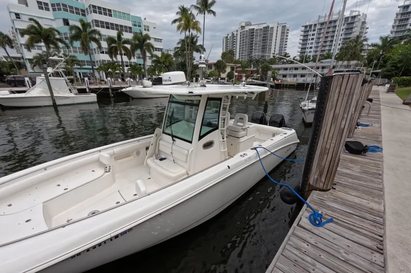 32 Boston Whaler Outrage 2013 Yacht Photos Pics 2013 Boston Whaler 320 Outrage docked at marina with modern buildings in background.