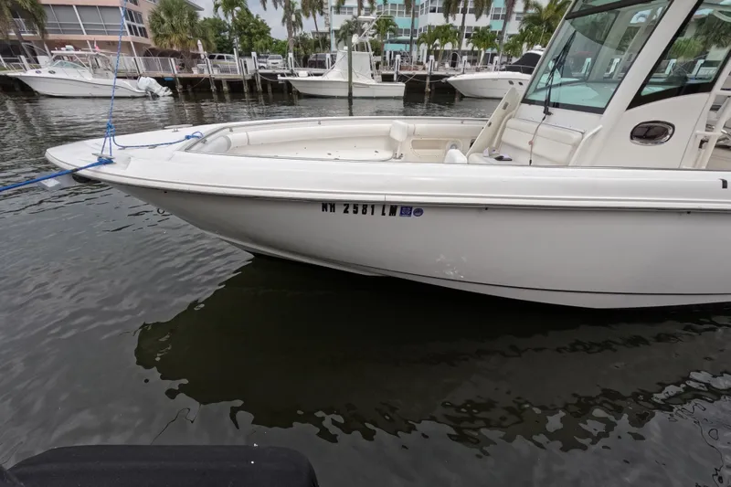 32 Boston Whaler Outrage 2013 Yacht Photos Pics 2013 Boston Whaler 320 Outrage boat docked in marina, side view.